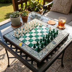 May include: A square chess set with a green and white chequered board. The chess pieces are white and green. The board is framed in dark wood and has an iridescent border. A Yin Yang symbol is on the board.