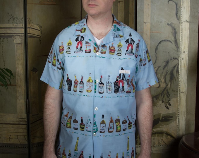 Vintage 1960s Novelty Print Cotton Blend Loop Collar Shirt with Liquor Bottle Theme from Virgin Islands in Rare Blue Colorway