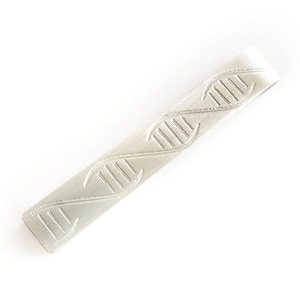May include: A silver tie clip with a DNA double helix design.