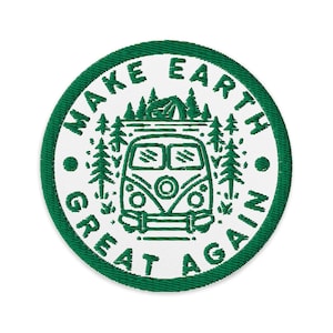 Puede incluir: Parche bordado con borde verde y centro blanco. El parche presenta una ilustración verde de una furgoneta camper, árboles y una tienda de campaña. El texto "MAKE EARTH GREAT AGAIN" está bordado en verde alrededor del borde.