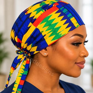 May include: A scrub cap featuring a vibrant geometric pattern in bright yellow, green, blue, and red. The head covering has a fitted crown and two long fabric ties at the back that allow for an adjustable fit, securing the cap comfortably in place.