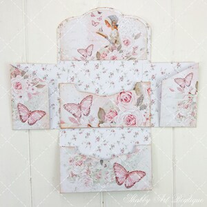 May include: A set of four decorative envelopes with a floral and butterfly design. The envelopes are made of paper and have a vintage aesthetic. The envelopes are folded and ready to be used.