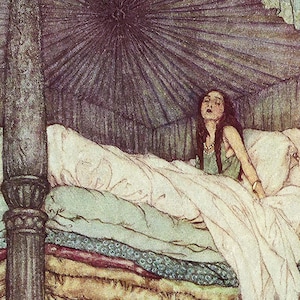 A woman with long brown hair lies in a bed with a canopy. The bed has many layers of bedding in shades of brown, green, and white.