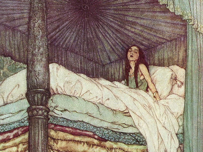 A woman with long brown hair lies in a bed with a canopy. The bed has many layers of bedding in shades of brown, green, and white.