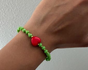 Festive Grinch stretch bracelet with heart accent bead