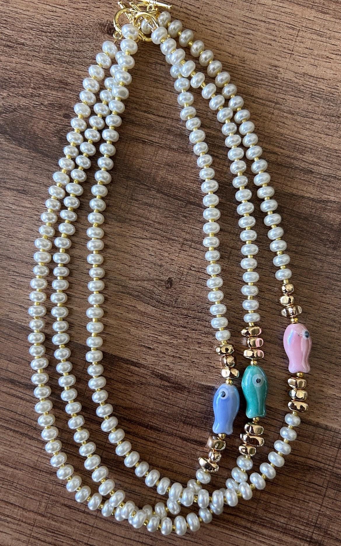 Glass pearl beaded necklace with fish bead and gold accent beads