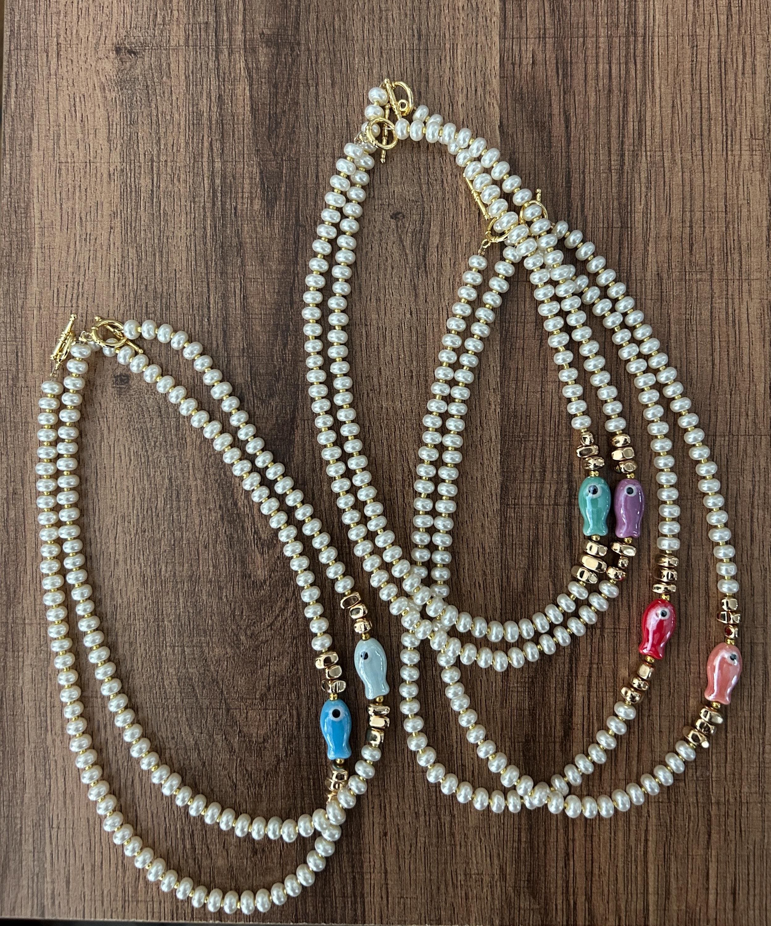 Glass pearl beaded necklace with fish bead and gold accent beads