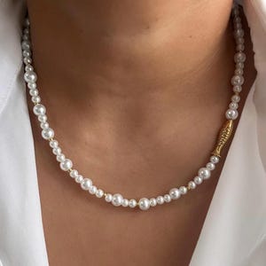 Glass pearl beaded necklace with gold fish bead and gold accent beads