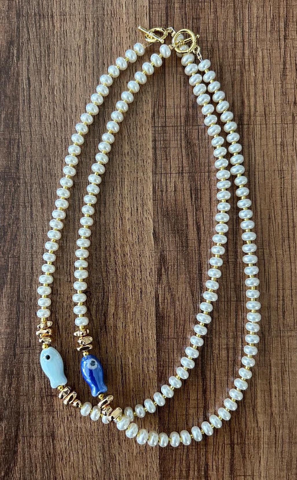 Glass pearl beaded necklace with fish bead and gold accent beads
