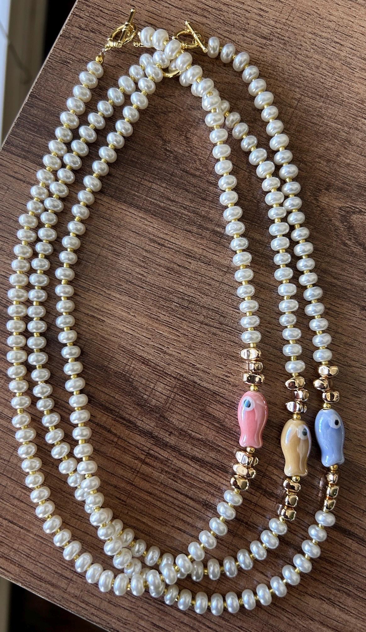 Glass pearl beaded necklace with fish bead and gold accent beads