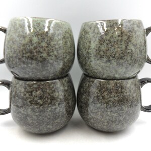 Set of 4 Reactive Glaze Sphere Cuddle Mugs in Leopard and Freckles.