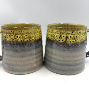 Set of 2 Reactive Glaze Creme Brulee Mugs in Yellow Snake Eye Glaze.