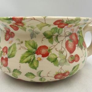 May include: A handmade wooden sign with the word "Welcome" in a handwritten style. The sign is painted white with a distressed finish, and a small green leaf is attached. The sign is approximately 30 cm wide and 15 cm tall.