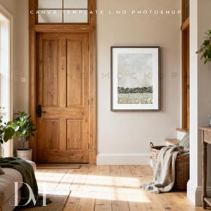 May include: A framed landscape art print hangs on a beige wall in a well-lit room. A large wooden door and a woven basket with a blanket are also visible. The text "CANVA TEMPLATE | NO PHOTOSHOP" is at the top.