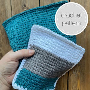 May include: Two crocheted dishcloths, one teal, one with teal, white, and gray stripes.  "crochet pattern" is written on a white circle with black dots.