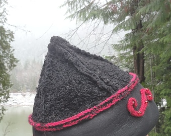 Mongolian, Cossack, Norse, Viking  style hat black persian lamb wool, red lucet  applicque and garnet beads.