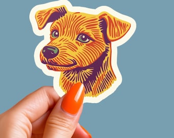 May include: A sticker featuring a stylized illustration of a dog's head. The dog has brown, orange, and yellow fur with a purple nose and black eyes. The sticker is on a white background.