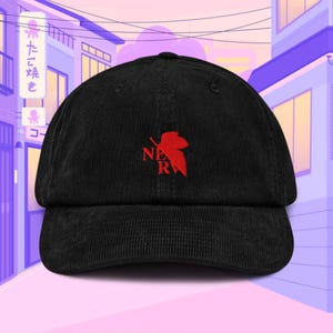 May include: Black corduroy baseball cap with a red embroidered logo of a leaf with the letters "NER" inside.