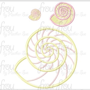 May include: A set of three embroidered seashells in pink and yellow. The largest seashell is a spiral with a detailed design. The two smaller seashells are simple and round.