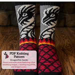 May include: A pair of knit socks featuring a black and white dragon graphic on the leg, a band of orange and yellow flames, and a red and black diamond pattern resembling scales on the foot. Text on the image reads: PDF Knitting Pattern.