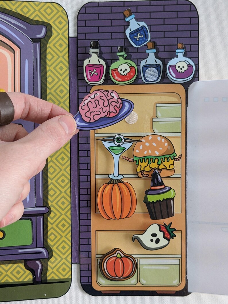 May include: A colorful, illustrated, magnetic refrigerator with a variety of Halloween-themed items, including a brain, a pumpkin, a cupcake, a ghost, a burger, and a martini glass. The refrigerator is open and the items are on the shelves.