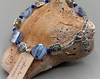 Handcrafted Glass Bead Bracelet with Silver Accents and a Silver lobster clasp.