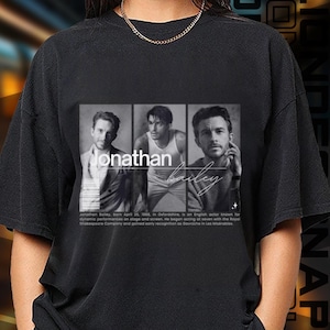 May include: Black t-shirt featuring a grayscale image of Jonathan Bailey. The image is divided into three sections, with the name "Jonathan" and "Bailey" in cursive script. Text below the image provides biographical information.