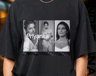 May include: Black t-shirt featuring a black and white graphic of Priyanka Chopra in three different poses. The word "Priyanka" is printed in white, with a signature below the images. The shirt has a crew neck and short sleeves.