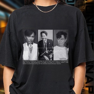 May include: Black t-shirt with a grayscale image of a man in three panels, with the name "Lee" and "Jungjae" in white script. The shirt includes biographical text below the images.