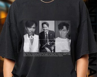 May include: Black t-shirt featuring a grayscale image of a man in three panels, with the name "Lee" and "Jungjae" in white script. The shirt includes biographical text below the images.