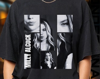 May include: Black t-shirt featuring a collage of black and white images of Milly Alcock. The design includes close-ups of her face and the name "MILLY ALCOCK" printed vertically in white on the left side of the shirt.
