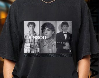 May include: Black t-shirt featuring a black and white image of a person in three different poses. The image has the text "Mason Thames" in a stylized font. The shirt has a crew neck and short sleeves.