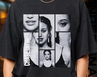 May include: Black t-shirt featuring a collage of a woman's face in grayscale. The design is divided into rectangular sections, with the text "CHASE INFINITY" printed vertically on the left side. The shirt has a round neckline and short sleeves.
