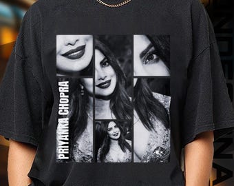 May include: Black t-shirt featuring a collage of black and white images of Priyanka Chopra. The design includes close-ups of her face and the text "PRIYANKA CHOPRA" in white vertical lettering on the left side. The shirt has a crew neck and short sleeves.
