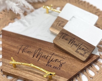 May include: A wooden serving tray with a white marble inlay. The tray has a gold branch handle and is engraved with "The Martins EST. 2025".