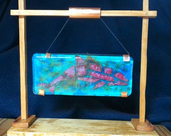 Dolphin a copper dolphin encased in fused glass art with wooden stand a gift for all dolphin lovers hanging from a 7 x 6 stand a 5 x 2 glass