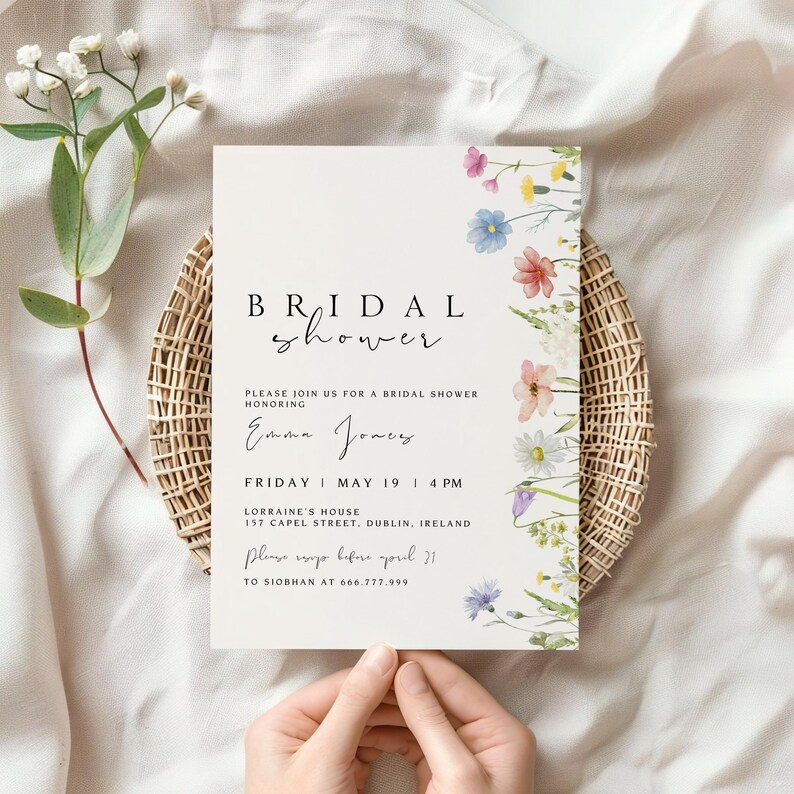May include: A white card with a floral design and the text "BRIDAL shower" in black script. The card also includes the text "PLEASE JOIN US FOR A BRIDAL SHOWER HONORING Emma Jones FRIDAY MAY 19 | 4 PM LORRAINE'S HOUSE 157 CAPEL STREET, DUBLIN, IRELAND Please RSVP before April 21 TO SIOBHAN AT 666.777.999"