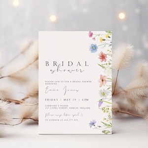 May include: A white bridal shower invitation with a floral border. The invitation reads "BRIDAL shower" and includes the text "Please join us for a bridal shower honoring Emma Jones. Friday, May 19, 4 PM. Lorraine's House, 157 Capel Street, Dublin, Ireland. Please RSVP before April 21 to Siobhan at 666.777.999."