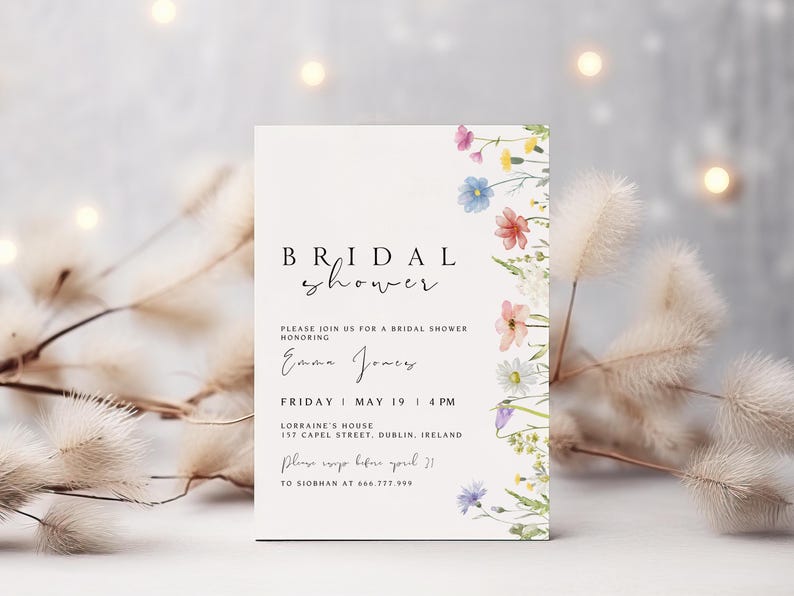 May include: A white bridal shower invitation with a floral border. The invitation reads "BRIDAL shower" and includes the text "Please join us for a bridal shower honoring Emma Jones. Friday, May 19, 4 PM. Lorraine's House, 157 Capel Street, Dublin, Ireland. Please RSVP before April 21 to Siobhan at 666.777.999."