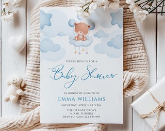 May include: A blue and white baby shower invitation with a cartoon teddy bear holding a balloon in a cloud. The invitation says "Please join us for a Baby Shower" in honor of Emma Williams. The event is on Saturday, April 5 at 2 PM at The Orange Grove in Miami, Florida. RSVP to Faith at 222.444.999.