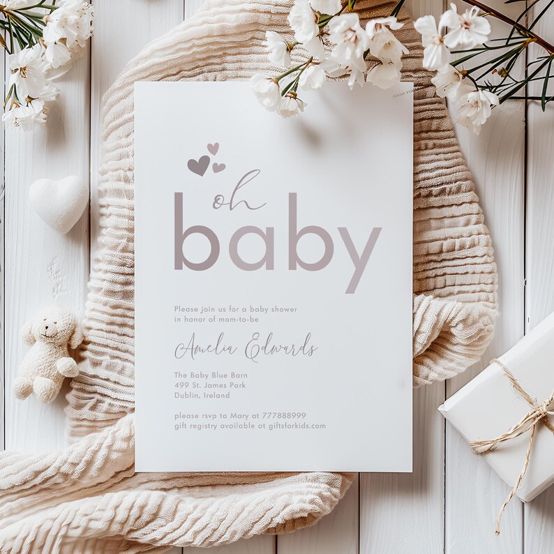 May include: A white baby shower invitation with pink hearts and the text "oh baby" in a pink gradient. The invitation includes the name "Amelia Edwards" and details for the shower, including the location, date, and contact information.