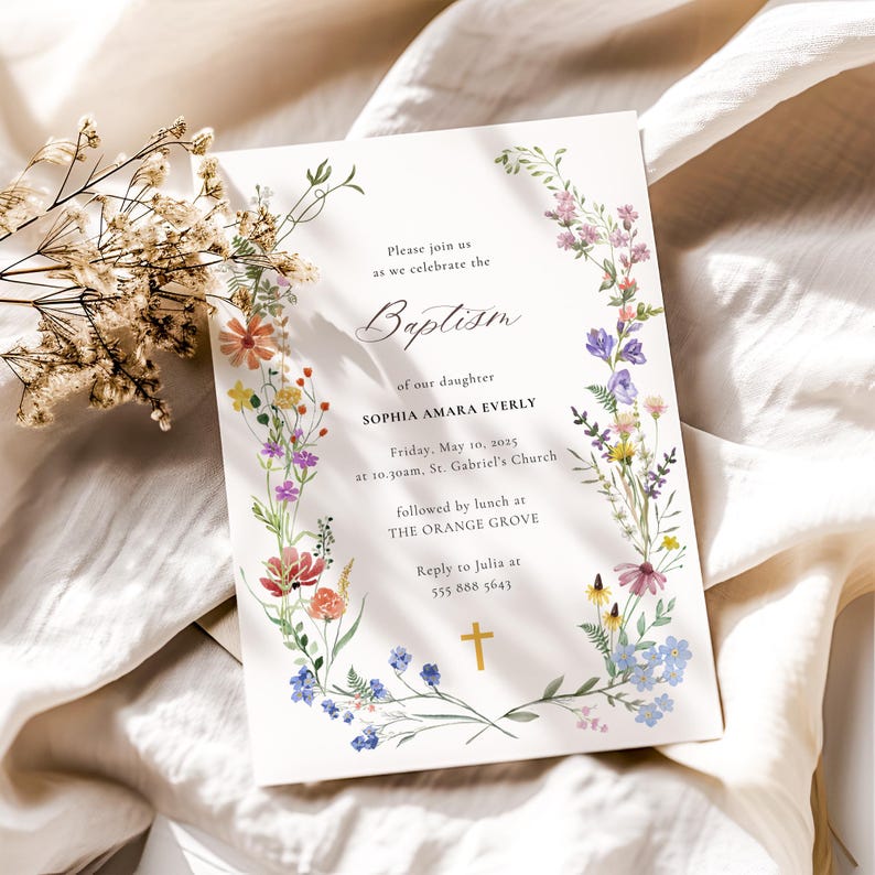 Op de afbeelding: Een witte kaart met een bloemige rand en een gouden kruis. De kaart is een uitnodiging voor de doop van Sophia Amara Everly. Het evenement vindt plaats op vrijdag 10 mei 2025 om 10:30 uur in de St. Gabriel's Church, gevolgd door een lunch in The Orange Grove.  RSVP naar Julia op 555 888 5643.