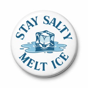 May include: White button with the text "STAY SALTY MELT ICE" in blue. A blue ice cube is melting on a blue puddle in the center of the button. The button is round.