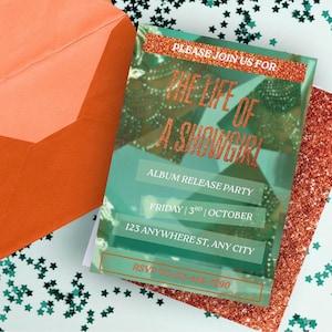 May include: An invitation with the text "The Life of a Showgirl" in glittery orange font. The invitation includes details for an album release party, date, and location. An orange envelope and glittery accents surround the invitation.