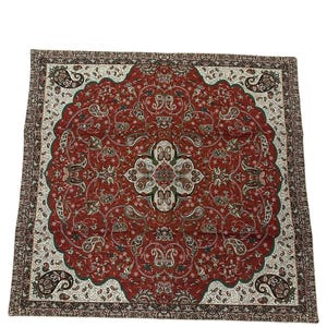 May include: A rectangular, ornate rug with a central medallion design. The rug features a deep red background with intricate paisley and floral patterns in white, green, and brown. The border is a darker brown with a repeating pattern.