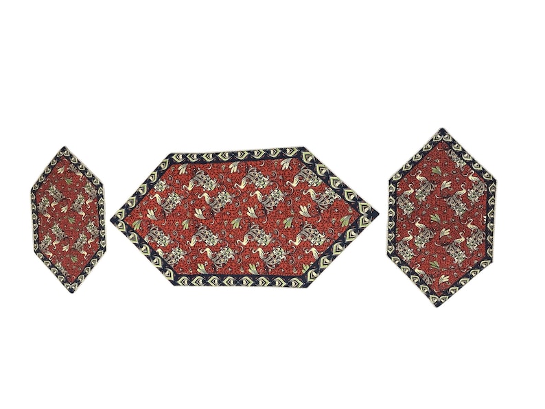 May include: A set of three decorative table mats. The mats have a red background with a floral pattern in gold and black. The edges are trimmed with a dark blue border. The mats are in a hexagonal shape.