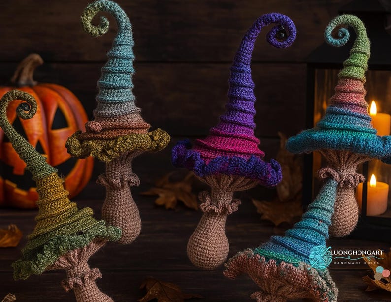 May include: A collection of handmade crochet mushroom decorations in various colors. Each mushroom features a spiraled, pointed hat in shades of blue, purple, green, and orange. The stems are a light brown color. A carved pumpkin and candles are in the background.