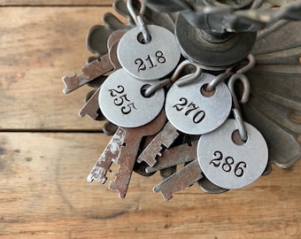 Old rusty keys with numbered tags, Locker tags, Metal numbers, Assemblage supplies