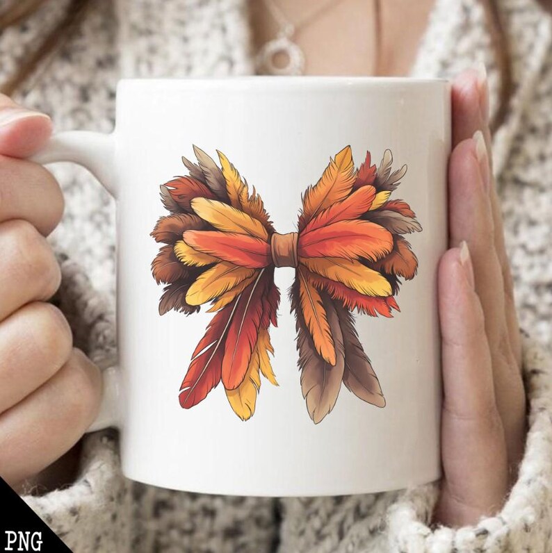 May include: White ceramic mug with a colorful illustration of a bow made of feathers. The feathers are in shades of orange, brown, and yellow.