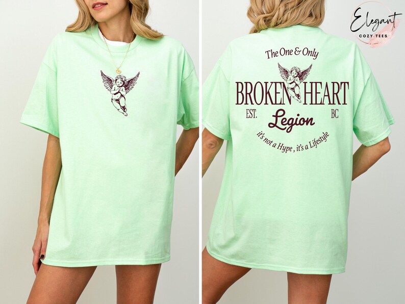 Mint green t-shirt with "Broken Heart Legion" graphic and cherub design.